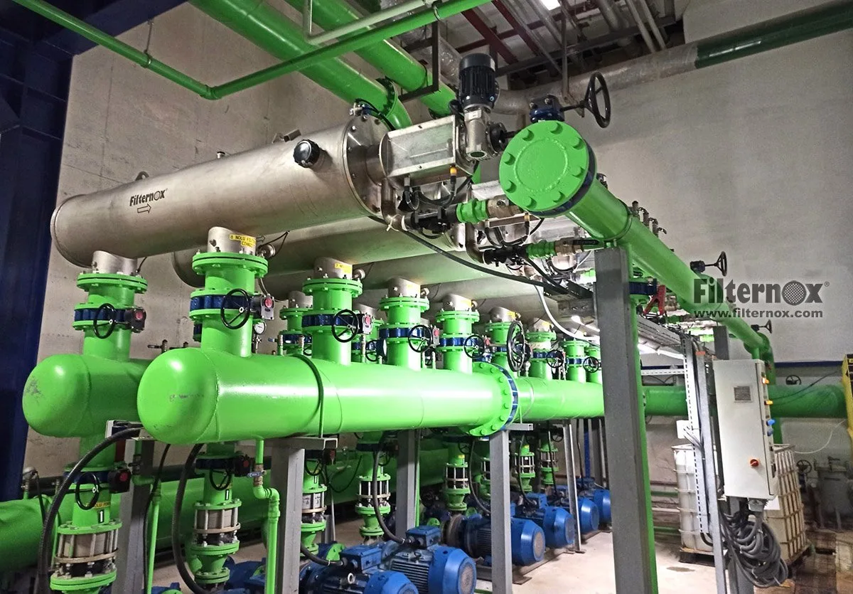 Cooling tower water filtration for compressor protection